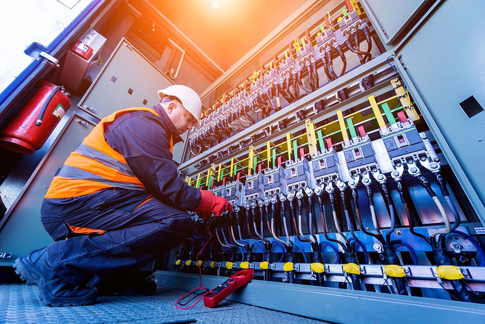 Electrician working on an industrial electrical board